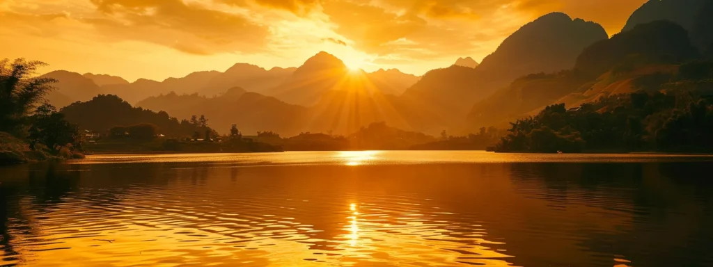 a vibrant sunset casts a warm golden hue over a tranquil lake, where majestic mountains reflect perfectly on the glassy water, creating a serene and picturesque landscape.